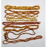 A QUANTITY OF AMBER BEADS, various sizes and colours, together with a coral necklace. Amber weight