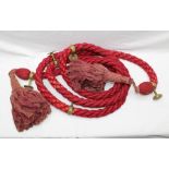 A LENGTH OF RED STAIR ROPE with five brass fittings and large tassell ends, 384cm long