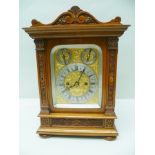 AN EDWARDIAN WALNUT CASED EIGHT DAY MANTEL CLOCK fitted twin fusee chiming movement, the case with