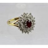 A DIAMOND AND CENTRAL RUBY LADY'S CLUSTER RING, yellow gold band, mark worn, considered to be 18ct