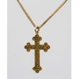 AN ORNATE 15CT GOLD CROSS mounted on a 9ct gold chain with bolt ring clasp