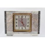 A "TOKYO CLOCK" of Art Deco design, in an angular specimen marble case, the square dial with