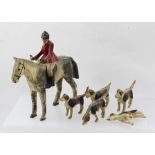 AN EARLY 20TH CENTURY CARVED WOOD AND HAND PAINTED HUNTSMAN ON A DAPPLE GREY HORSE, overall 18cm