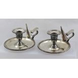 A PAIR OF SILVER PLATED CHAMBERSTICKS, with removable drip pans and snuffers