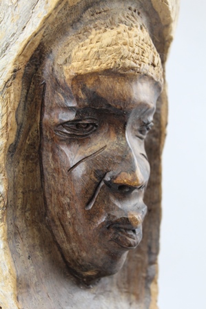 AN AFRICAN HARDWOOD CARVING, a mask emerges within a branch segment, 37cm high - Image 3 of 3