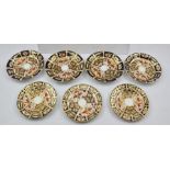 THREE ROYAL CROWN DERBY IMARI PATTERNED PORCELAIN SIDE PLATES, 13cm diameter, and four SAUCERS