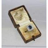 AN 18CT GOLD ART DECO DESIGN DRESS RING set central oval sapphire surrounded by diamonds in a square