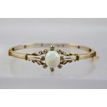 A VICTORIAN GOLD LARGE OPAL AND 8 STONE DIAMOND CLUSTER BRACELET