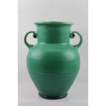 C.H. BRANNAM OF BARNSTABLE AN ARTS & CRAFTS POTTERY TWIN-HANDLED VASE, with running green glaze