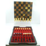 A CHESS/DRAUGHTS GAMES COMPENDIUM with marble chess board on a compartmental box base, 36cm x 36cm