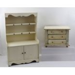 A LATE VICTORIAN PAINTED PINE DOLL'S CHEST OF THREE DRAWERS raised on turned feet, 26cm wide,