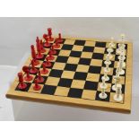 A 19TH CENTURY TURNED BONE "BARLEY CORN" PATTERNED CHESS SET, both stained red and natural, the