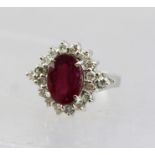 AN 18CT WHITE GOLD CLUSTER DRESS RING, set central large ruby with diamond surround, size N tight