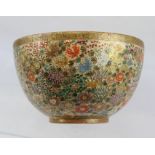 A JAPANESE MEIJI PERIOD SATSUMA EARTHENWARE BOWL, overall floral painted and gilded, seal mark to