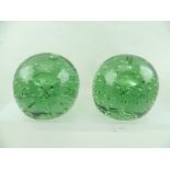 TWO VICTORIAN "DUMPY" GLASS WEIGHTS, green tinted with bubble inclusions, 11cm high