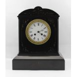 A VICTORIAN BLACK SLATE CASED MANTEL CLOCK with carved decoration, gilded, with white enamel dial