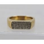 A HEAVY 9CT GOLD RING set with sixty small diamonds within a central flat tablet, size T