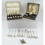A SELECTION OF SILVER ITEMS including; Art Nouveau design tea spoons and sugar nips, a cased set