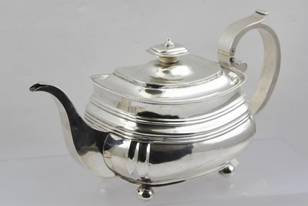 JOHN COWIE A GEORGE III SILVER TEAPOT of lobed rectangular form, hinged cover with silver knop,