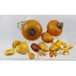AN AMBER AND AMBEROID PART NECKLET comprising two large tomato shape bead pendants and fourteen