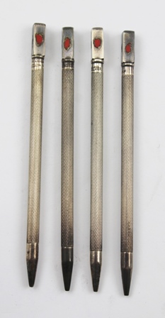 A SET OF FOUR SILVER COLOURED METAL AND ENAMEL BRIDGE SUITE MARKERS, each with a knurled shaft,