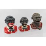 THREE BLACK BOY CAST IRON MONEY BOXES, each lifts a coin to their opening mouth via an articulated
