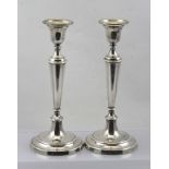 M.C. HERSEY & CO. LTD. A PAIR OF SPUN SILVER AND LOADED CANDLESTICKS, each having inverted bell