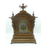 A "JUNGHANS" LATE 19TH CENTURY MAHOGANY CASED MANTEL CLOCK, having arched dial with silvered chapter