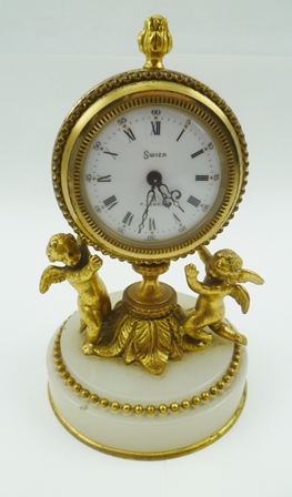 A "HALCYON DAYS" DECORATIVE FRENCH STYLE BOUDOIR CLOCK, having cast gilt brass frame as two putti