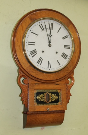 A LATE 19TH CENTURY AMERICAN OAK CASED DROP DIAL 8-DAY WALL CLOCK, the 29cm dial with Roman numerals