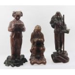 THREE CHINESE CULTURAL REVOLUTION CARVED WOOD FIGURES, each with a copy of the Chairman's "little