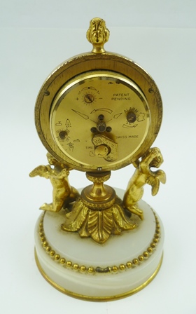 A "HALCYON DAYS" DECORATIVE FRENCH STYLE BOUDOIR CLOCK, having cast gilt brass frame as two putti - Image 2 of 2