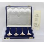 PERCY GREAVES A PRESENTATION SET OF FOUR BRITANNIA STANDARD SILVER SPOONS, each having a cast