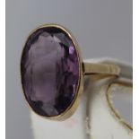 AN AMETHYST SET GOLD DRESS RING, the rub over setting stamped 9ct, set with an oval amethyst, size S