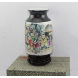 A CHINESE PORCELAIN TUBULAR FORM VASE, hand painted in the round in the famille rose palette of