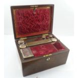 A 19TH CENTURY ROSEWOOD TRAVELLING VANITY CASE, opening to reveal a red velvet interior fitted