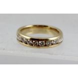 A 14K AND DIAMOND HALF ETERNITY RING, set with twelve diamonds, stamped "14k", size I tight