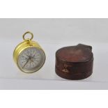 A VICTORIAN GILT BRASS TRAVELLER'S POCKET COMPASS, having ring top, silvered calibrated dial "