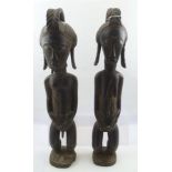 A PAIR OF EARLY TO MID-20TH CENTURY CARVED EBONISED WOOD AFRICAN FIGURES, male and female, 56cm high