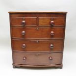 A 19TH CENTURY MAHOGANY BOW FRONTED CHEST of two short over three long graduated drawers with knob