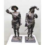 A PAIR OF 20TH CENTURY BRONZE FIGURES MODELLED AS 17TH CENTURY CAVALIERS with drawn swords and broad