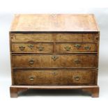 A PRICIPALLY 18TH CENTURY WALNUT BUREAU having feather banded full width fall-down writing slope