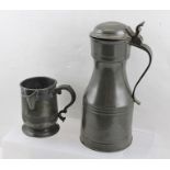 A 17TH CENTURY DESIGN PEWTER FLAGON with thumb catch hinged cover, inscribed "TT EC", of waisted