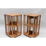 A PAIR OF 20TH CENTURY ELM REVOLVING BOOKCASES, fitted middle tier, 75cm high x 45cm square