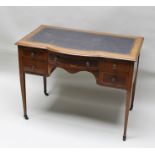 AN EDWARDIAN MAHOGANY WRITING TABLE having arched central section, top fitted tooled leather writing