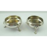 A PAIR OF EARLY VICTORIAN SILVER SALTS of plain circular Georgian design, each raised on three pad