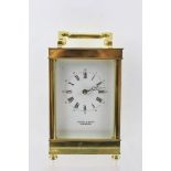 A 20TH CENTURY BRASS CASED CARRIAGE CLOCK, with hinged bale handle, the white enamel dial with Roman