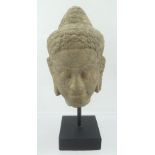 AN EARLY CARVED SANDSTONE HEAD OF BUDDHA, considered to be approximately circa 10th century from