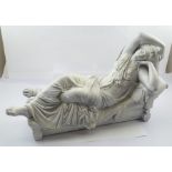 A CAST METAL FIGURE OF A CLASSICAL MAIDEN en repose, off-white painted finish, 56cm long