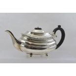 WILLIAM HUTTON & SONS LTD. AN EARLY 20TH CENTURY SILVER TEAPOT of Georgian design with gadrooned